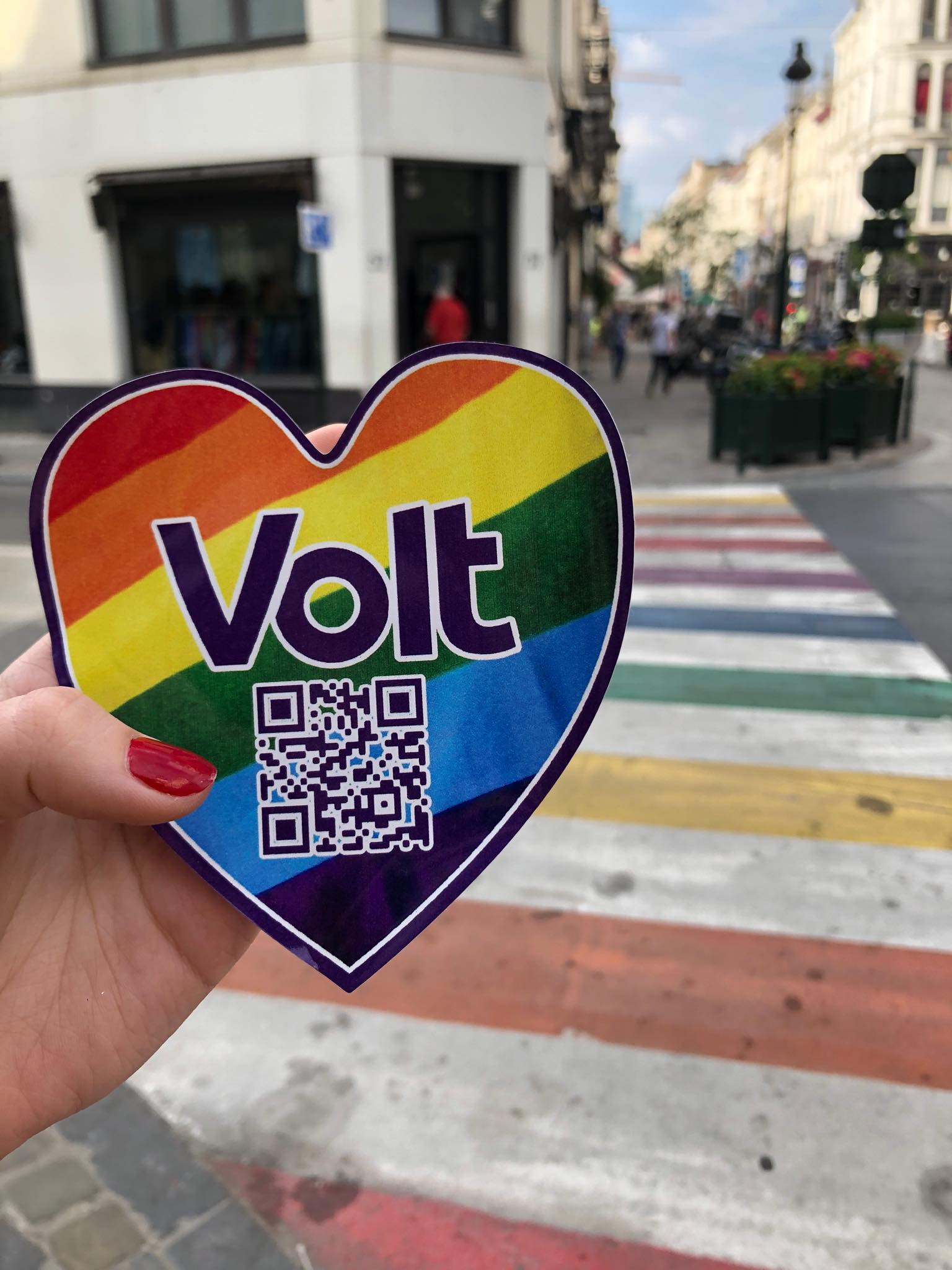 a heart shaped Volt sticker with QR code being held up